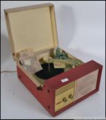 A vintage mid century two tone portable record player by Stella having a Philips deck