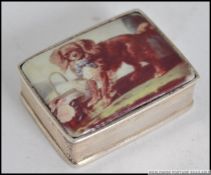 A silver metal ( stamped 925 ) decorated with an applied enamel panel depicting a dog 16.