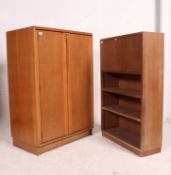 A vintage golden oak tallboy having cupboards and drawers together with a mid century students