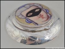 A silver embossed pill / snuff box with an applied pictorial enamel image of young maiden wearing a