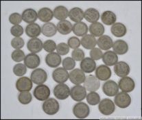 A collection of silver coins mainly one shilling coins being George V along with silver sixpences.
