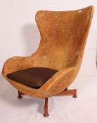 A 1970's retro egg swivel armchair raised on teak quadruped base ready for re-upholstery all in the