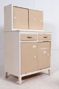 A vintage mid 20th century painted two tone shabby chic kitchen unit in caramel and white having