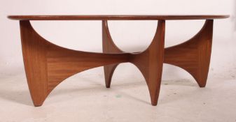 A retro teak wood atomic oval coffee table possibly G Plan, having a drop centre glass panel.