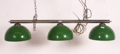 A modern brass ceiling mounted, hanging snooker table down light.