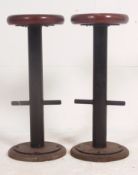 A pair of 1950's teak and tubular metal vintage bar stools with teak circular seats having metal