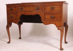 A 1950's Queen anne style walnut bow front writing table desk raised on cabriole legs with a series