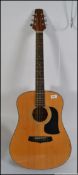 A good quality Aria acoustic guitar being steel strung having an adjustable stem