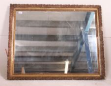 A 19th century ornate plaster gilt framed wall hanging mirror having a later central mirror panel.