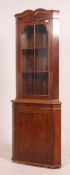 A Georgian style mahogany corner cabinet with upper astragal glazed door above single cupboard
