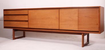 A good retro 1970's long Danish revival teak sideboard raised on shaped supports,