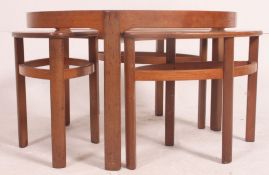 A 1970's Nathan Furniture retro circular glass top teak framed coffee table nest fitted with three