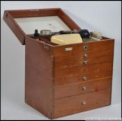 An early 20th century Industrial mahogany six drawer and hinge top dentist portable medical /