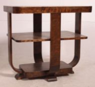 A 1930's Art Deco two tier occasional table being raised on bentwood supports with twin square