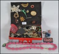 A quantity of assorted vintage and contemporary costume jewellery to include brooches, bangles etc.
