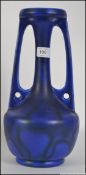 A good early 20th century Bretby Secessionist Art Nouveau style blue glazed twin handled vase.