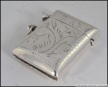 A 20th century vintage sterling silver vesta case being chase decorated with hinged cap. Weight 16.