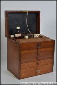 An early 20th century six drawer mahogany Industrial dentist portable table top cabinet chest