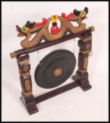 A large 20th century oriental Chinese hardwood painted decorated gong,