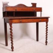 A 19th century continental mahogany inlaid writing table / dickens desk being raised on barley