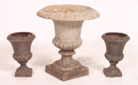 A collection of 3 vintage early 20th century cast iron garden campana urns,