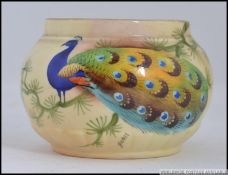 A Locke & Co Worcester vase of squat form decorated with a peacock on branch believed to be by H.