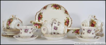 A collection of Royal Albert Country Roses bone China tea service, consisting of trios, creamer,
