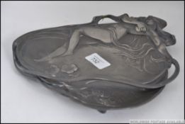 A stunning early 20th century WMF polish Art Nouveau card tray cast in relief with a maiden being