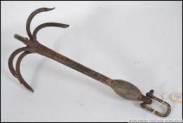 An early 20th century grappling hook of cast iron having 6 prongs with clasp to one end - ideal as