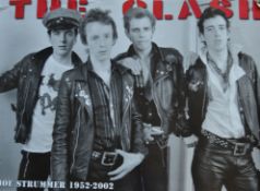 A large music poster for Joe Strummer of The Clash commemorating his life 1952 - 2002,