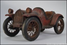 A large 20th century rustic vintage wooden model car with working wheels etc