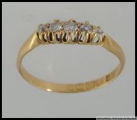 An Edwardian 18ct gold hallmarked diamond ring set with 5 old cut diamonds in a gypsy setting