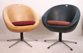 A retro 1970's pair of swivel egg chairs having the original vinyl upholstery and raised on chrome