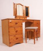 A 20th century antique style pine dressing table desk being raised on bun feet with pedestals of