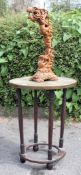 A 20th century Anglo - Indian oak brass topped occasional table along with a fantastic carved