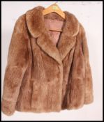 A vintage hip length medium brown fur coat, having a light brown satin lining,