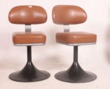 A rare pair of 1960's / 1970's tulip swivel diner chairs upholstered in brown vinyl with swivel