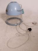 A vintage Pifco mid century Hair Dryer on stand finished in baby blue plastic.