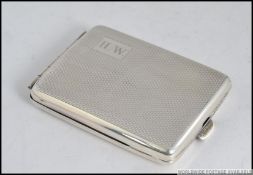 A silver hallmarked match holder case being engine turned with monogram cartouche.
