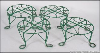 A collection of four decorative vintage painted wire work plant pot stands. Measures: 30cm W.