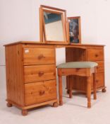 A 20th century antique style pine dressing table desk being raised on bun feet with pedestals of