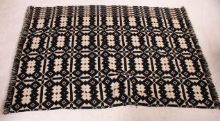 A vintage mid 20th century Welsh marriage blanket Traditional Welsh geometric blanket on a black