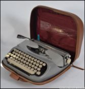 A vintage mid century portable typewriter in the original carry case by Royal