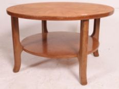 A 1970's teak Danish influence coffee table of circular form having inset lined cartwheel / cog