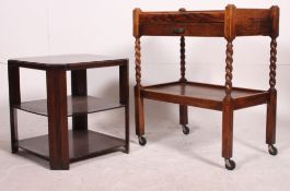 A 1930's golden oak two tier butlers tray trolley raised on castors together with a 1930's dark oak