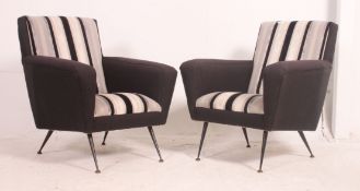 A stunning pair of 1960's armchairs raised on tapered legs having stunning period stripped black