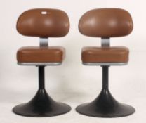 A rare pair of 1960's / 1970's tulip swivel diner chairs upholstered in brown vinyl with swivel