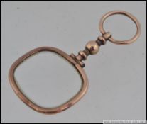 Early 20th century puzzler eye glass, tested as 9ct gold.