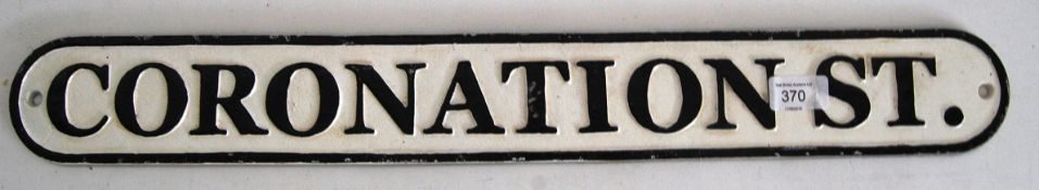A cast iron ' Coronation Street ' wall sign. Black and white, with raised lettering. 63cm long.