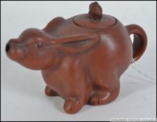 A 20th century Chinese yi - xing terracotta teapot in the shape of a hare complete with the lid,